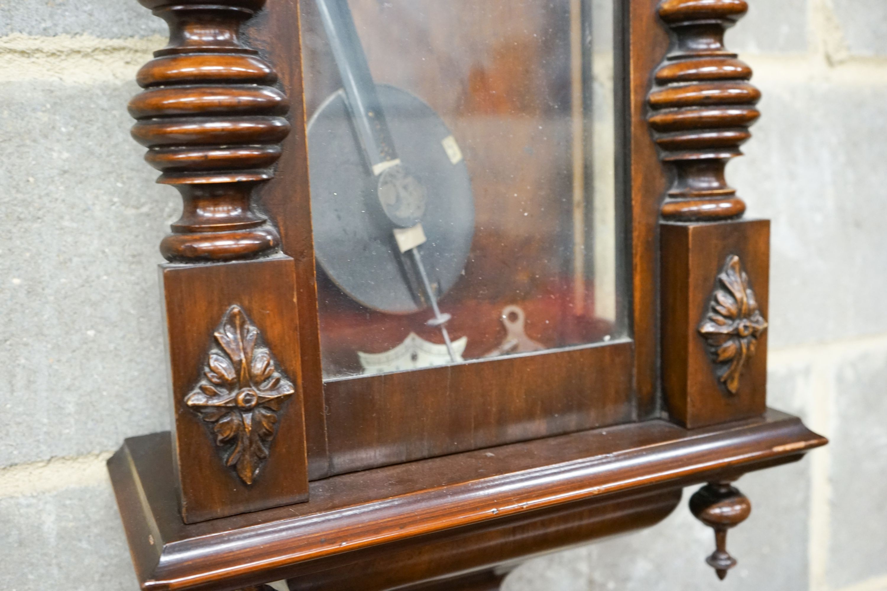 A Vienna style wall clock, having enamelled Roman dial and striking movement in glazed mahogany case, height 110cm